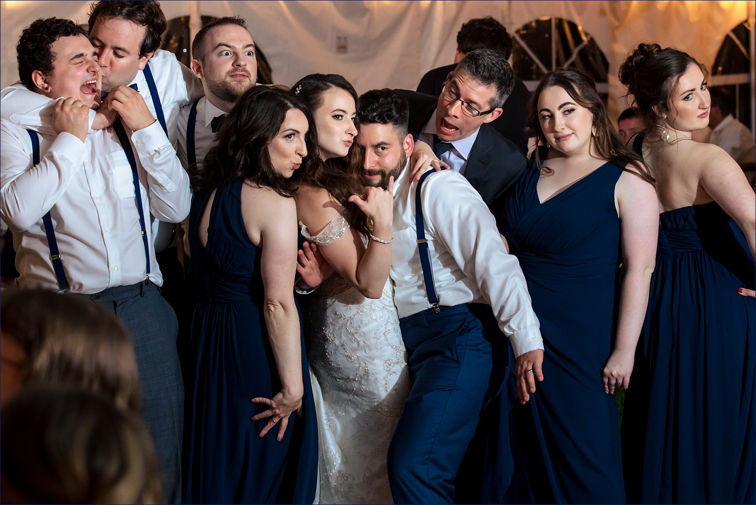 The bride and groom surround themselves with their best friends at the New Hampshire wedding reception