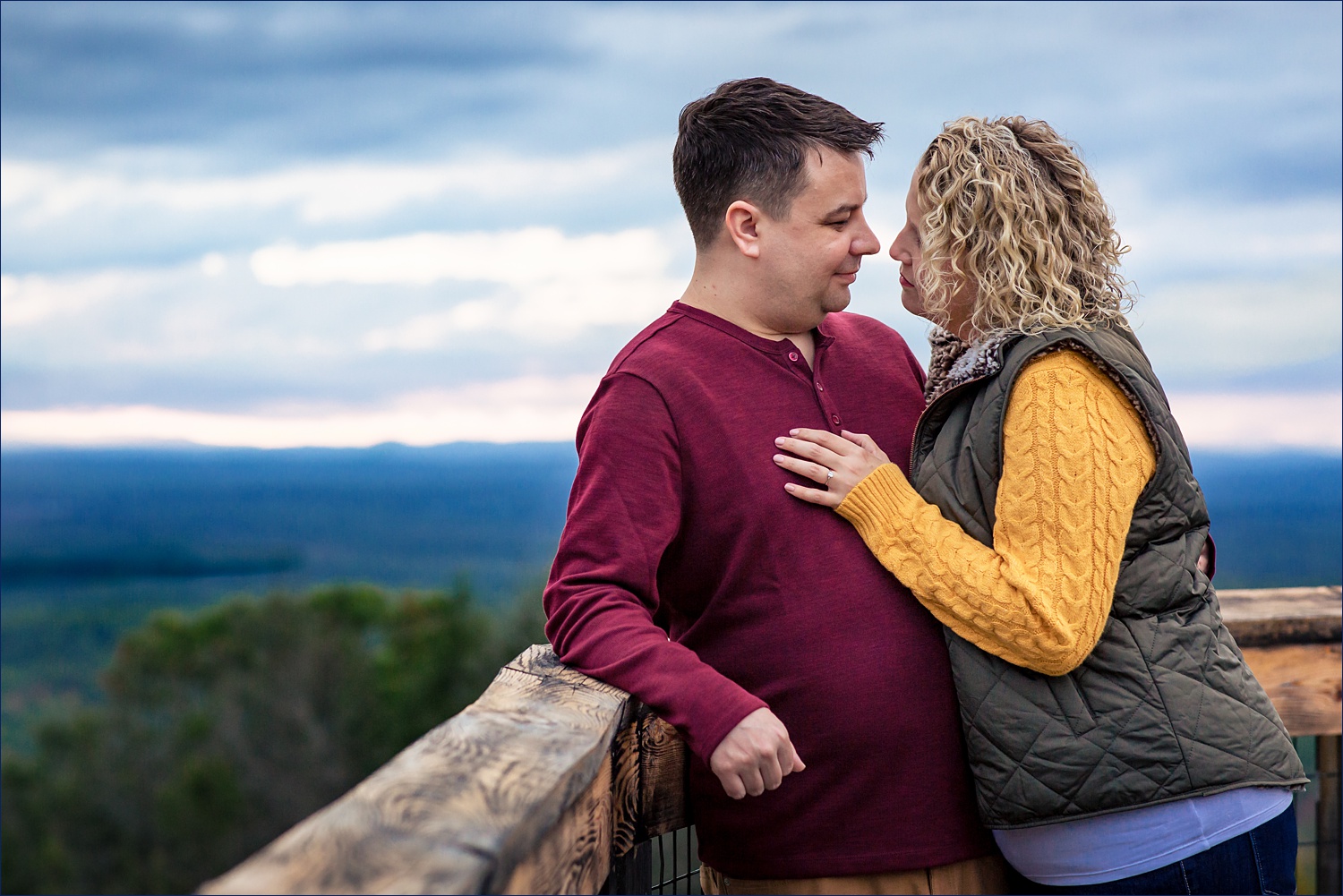 Looking into each other's eyes on their Maine engagement session in fall