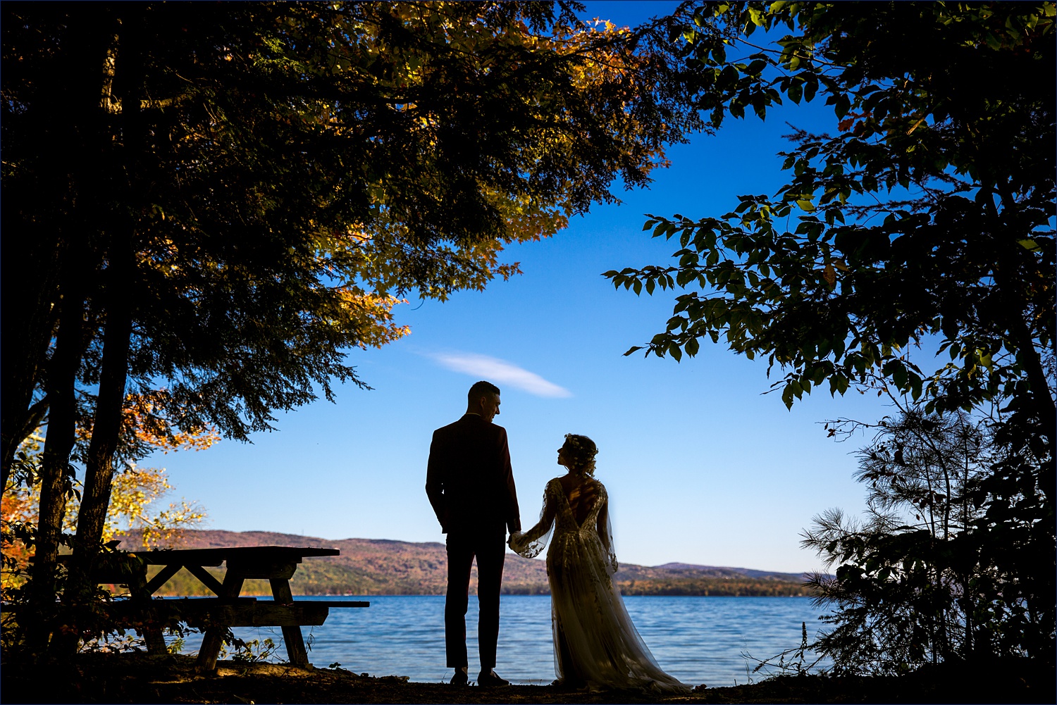 The bride and groom silhouetted by the White Mountain NH elopement