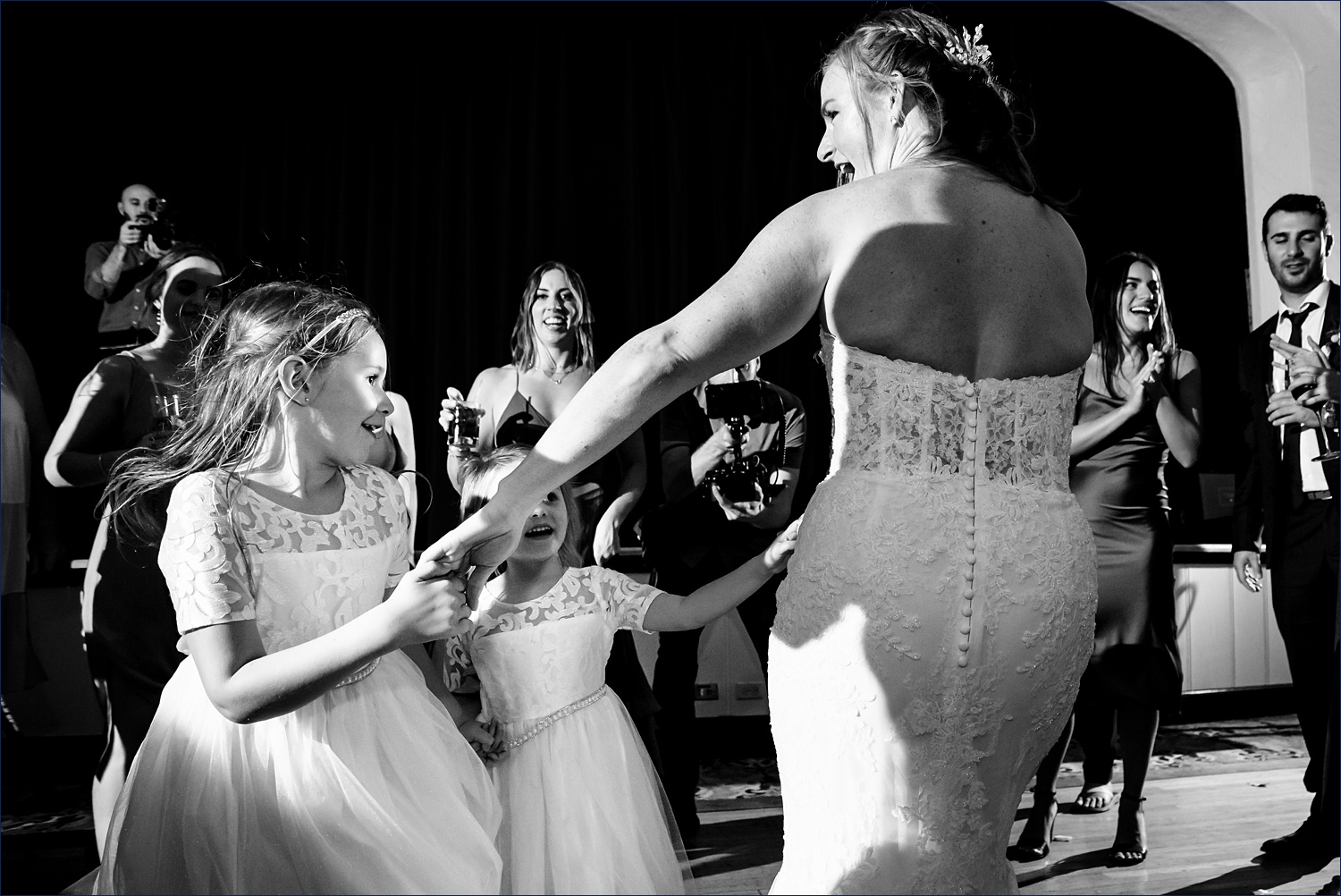 Bride dances with flower girls at the wedding reception