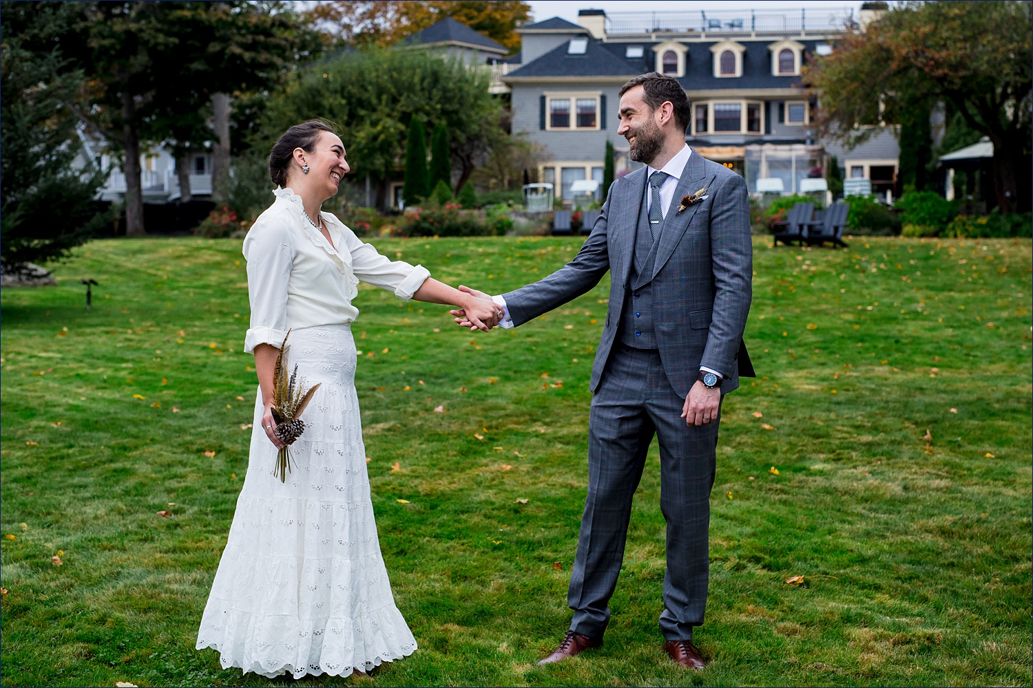 First look smiles from the couple out on the lawn of the Balance Rock Inn in Bar Harbor Maine