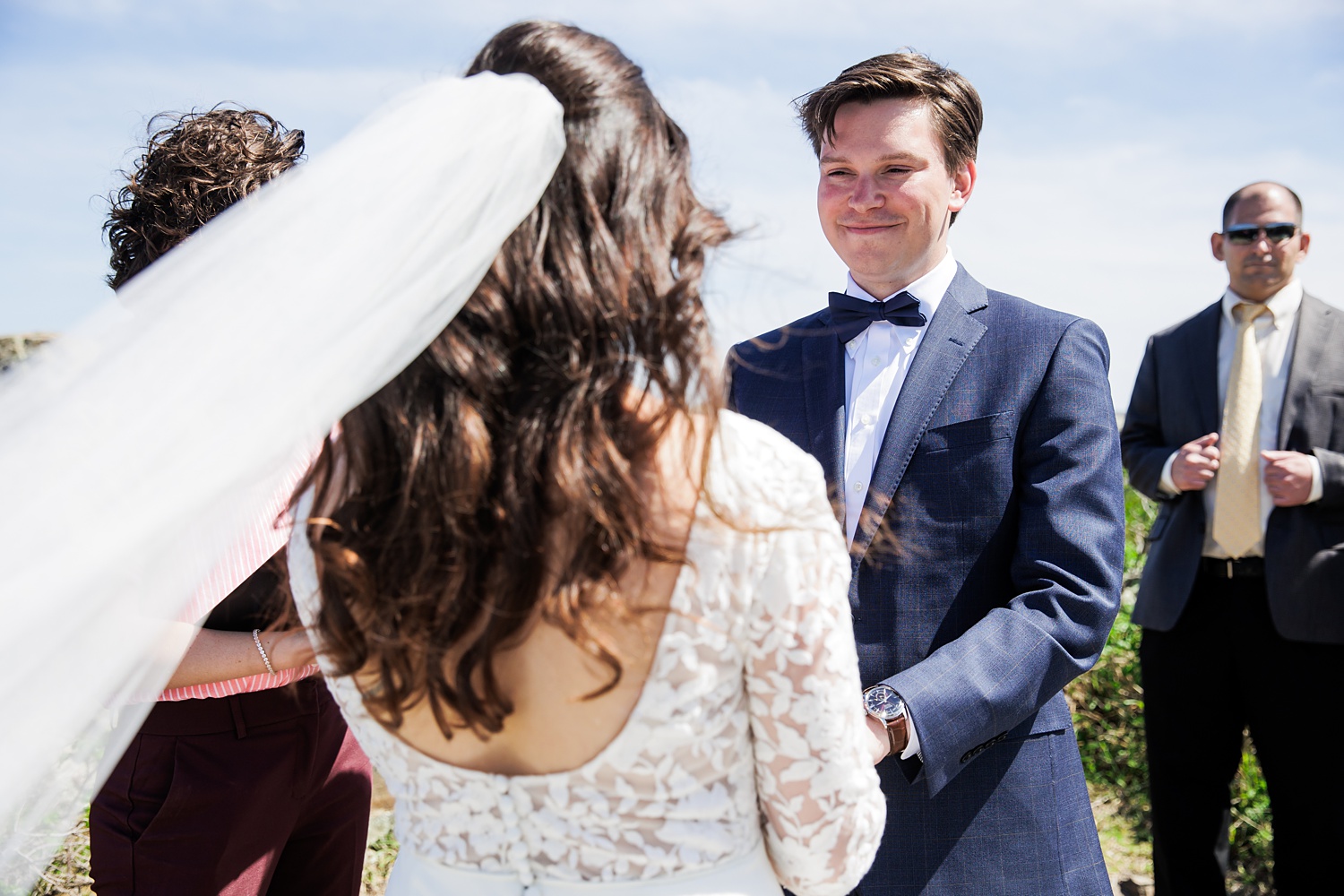 The groom looks lovingly at the bride during their outdoor ceremony