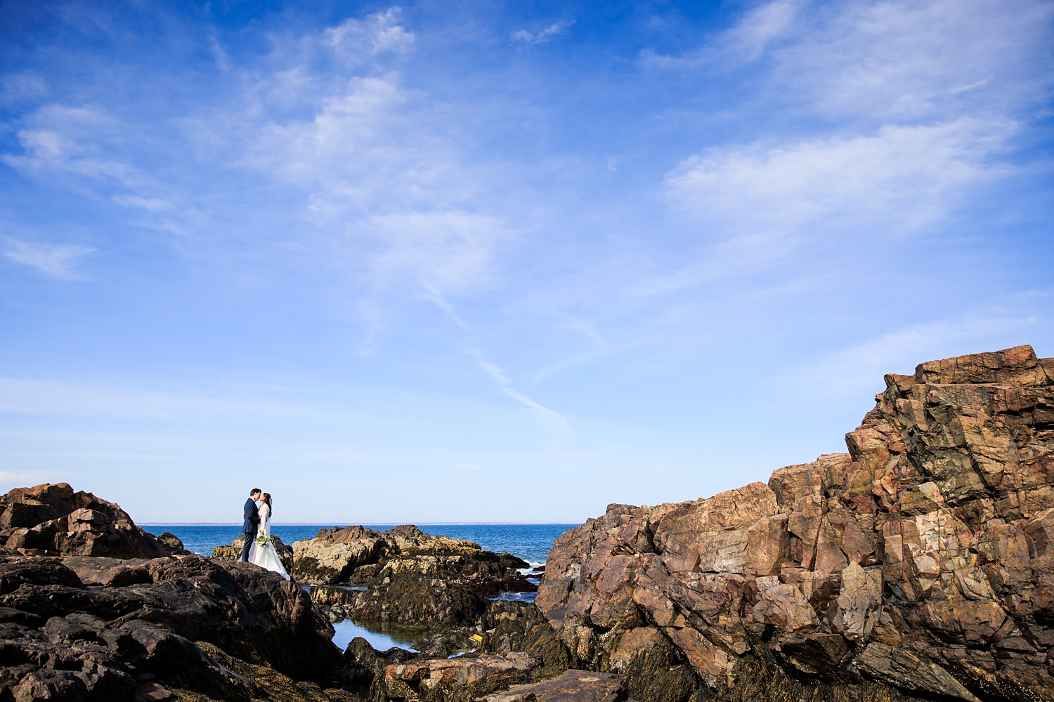 The couple and the rocks of coastal Maine on a bright sunny Maine day