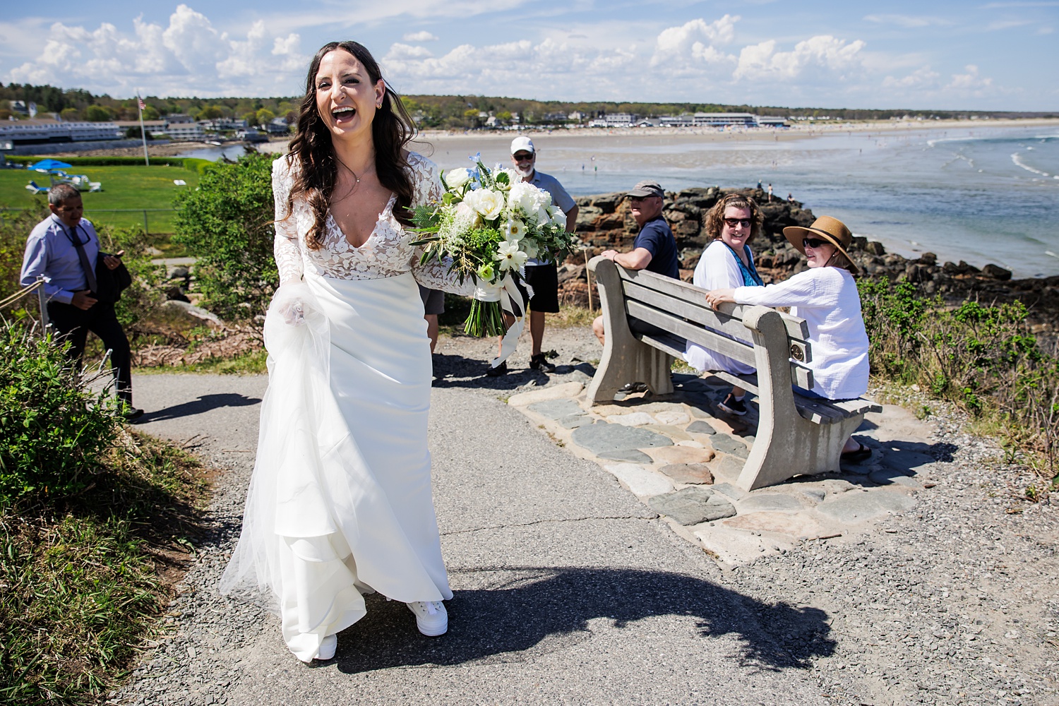 Tourists cheer on the bride as she heads to her Marginal Way Maine elopement