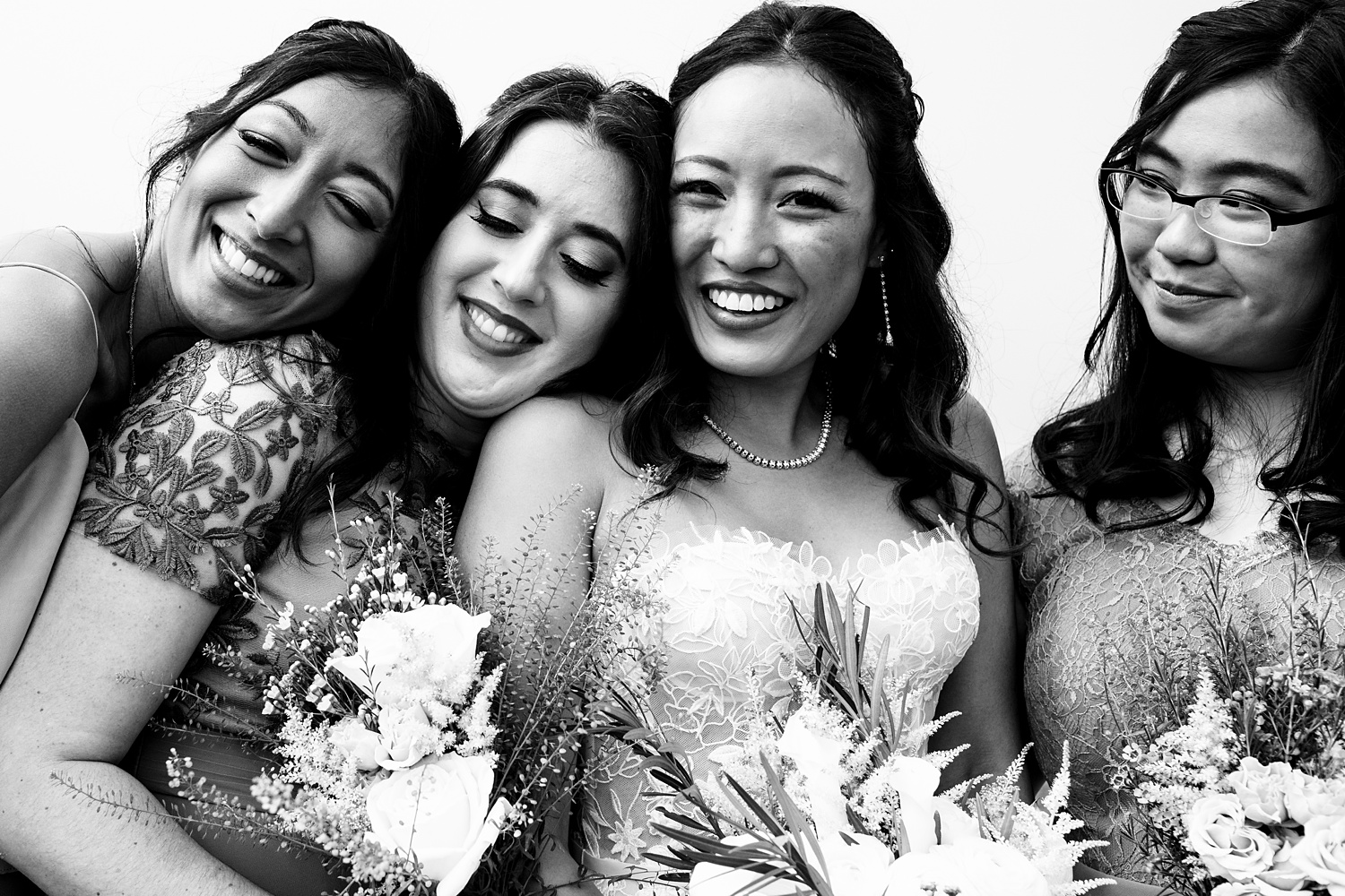 The bride with some of her closest friends cuddle close on the wedding day