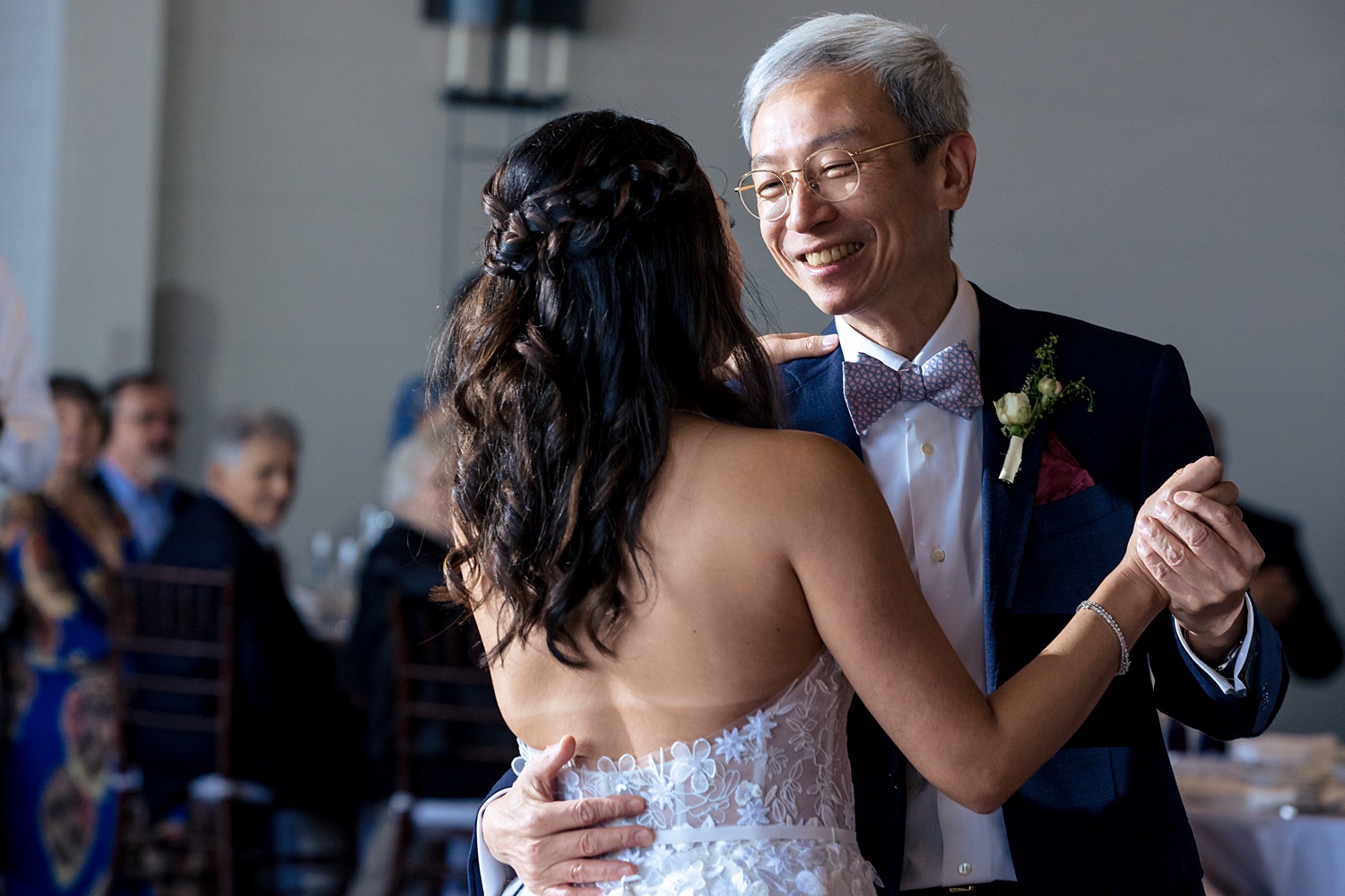 Father and daughter dance together during the wedding reception