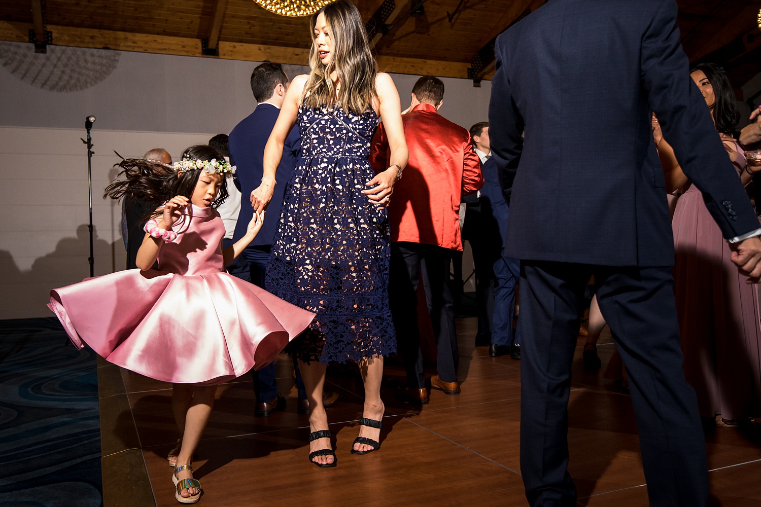 Flower girl dances with her mom at the wedding reception