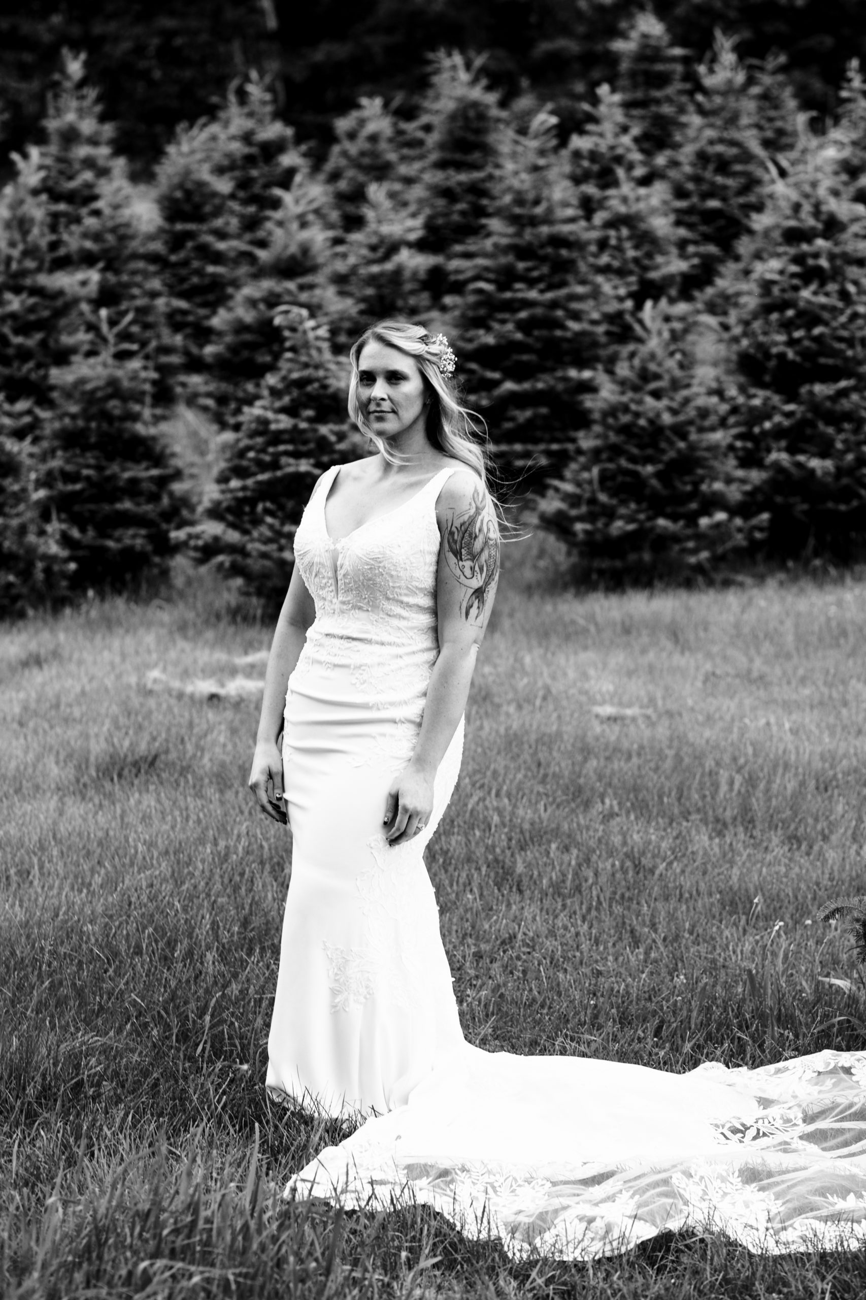 The bride among the green foliage of summer in maine