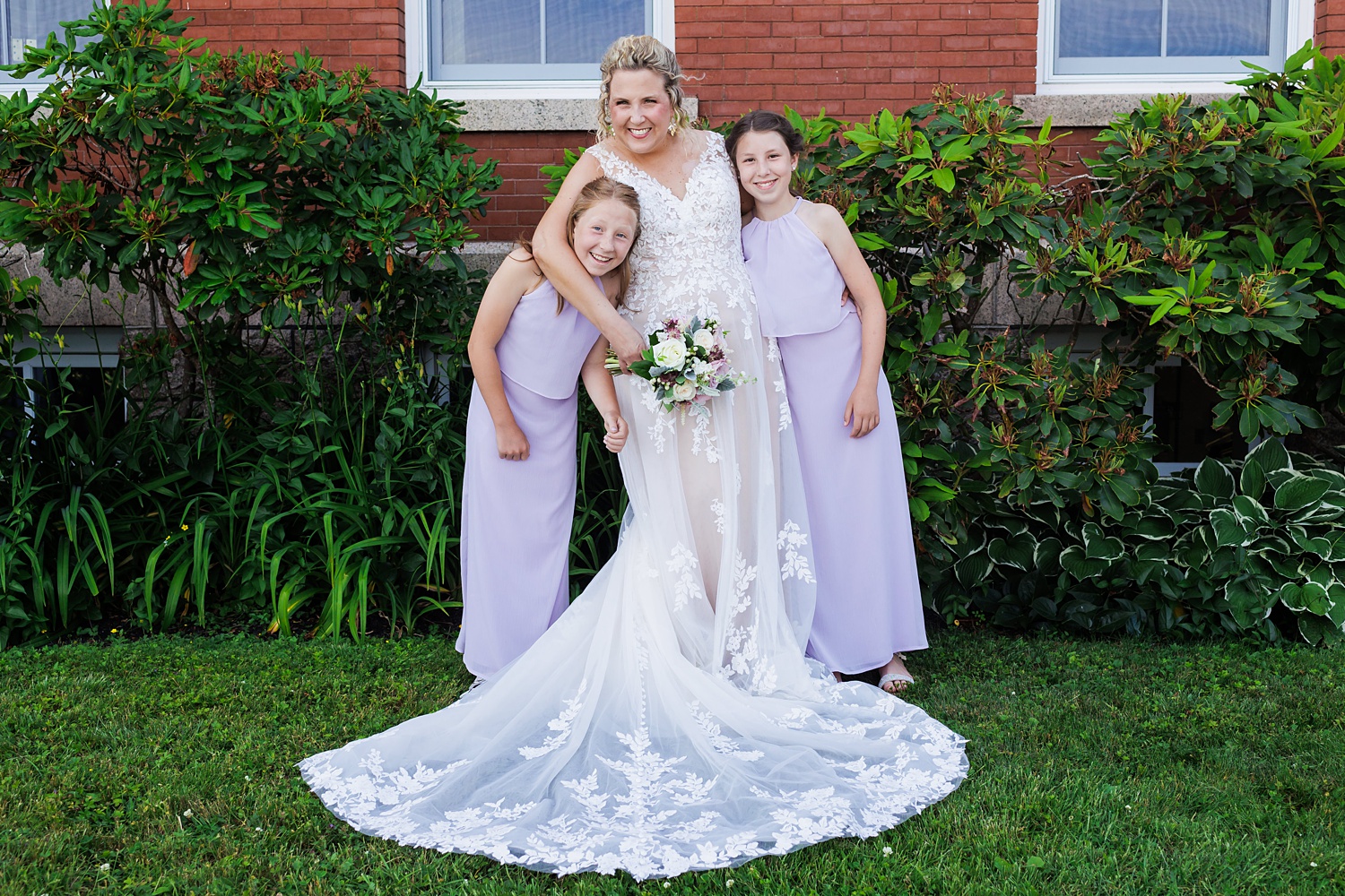 The bride and two of the youngest family members on the wedding day enjoy a little fun