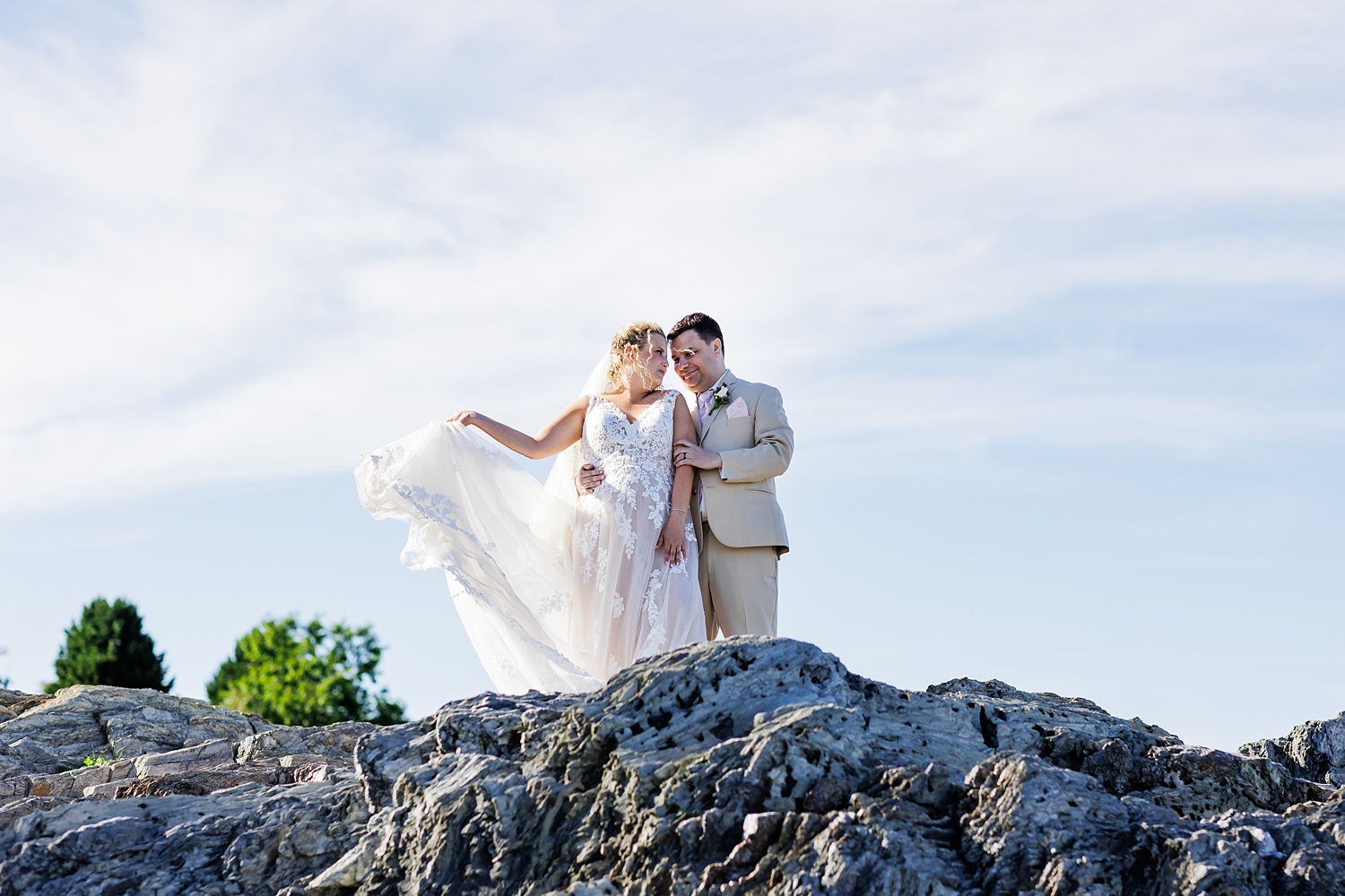 The bride and groom get close out on the rocks at Willard Beach in Maine