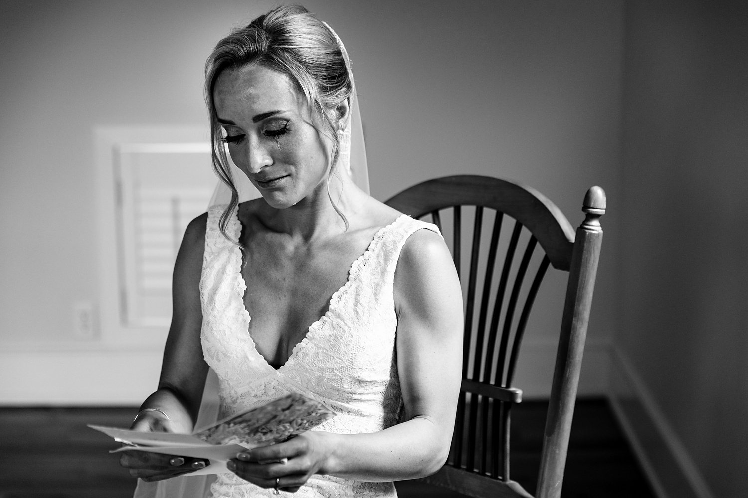 The bride cries while reading a card from the groom on her Cunningham Farm Maine wedding day