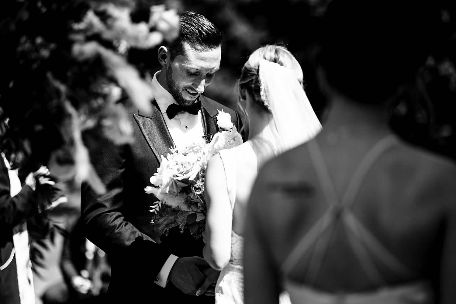 The groom laughs during the outdoor Maine wedding ceremony