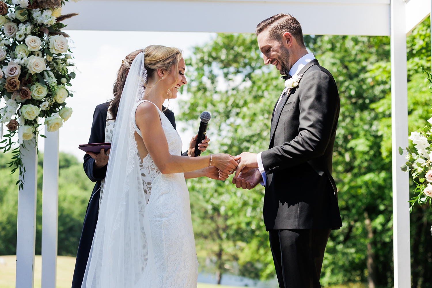 Exchanging wedding bands during the Maine outdoor ceremony