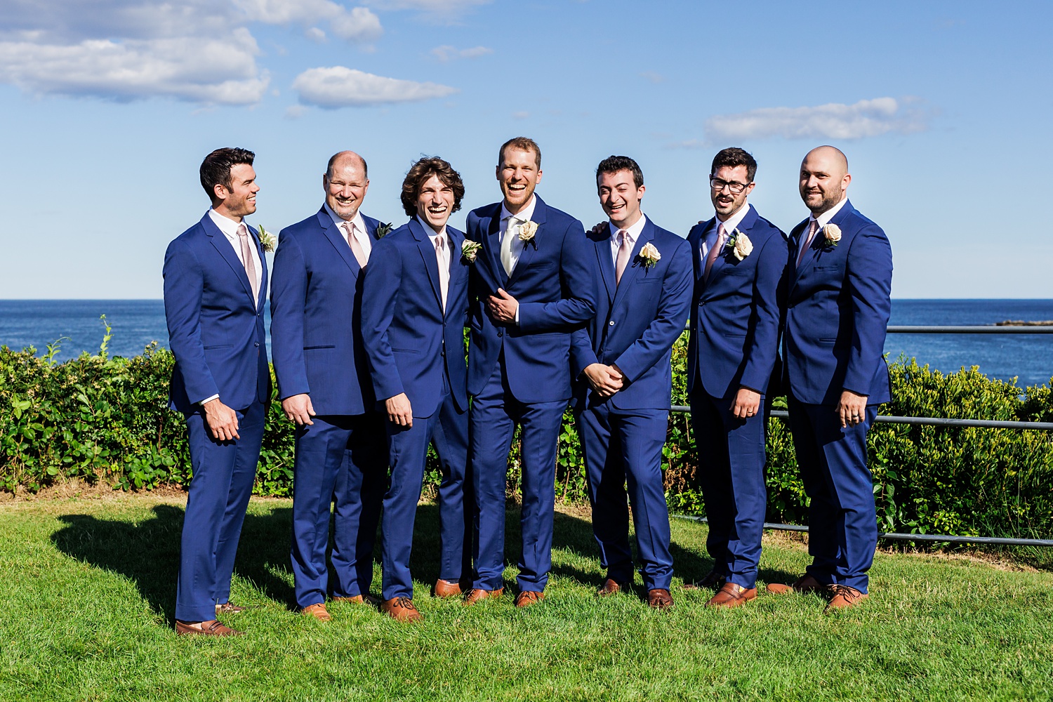 The groom and the groomsmen on the wedding day share a laugh