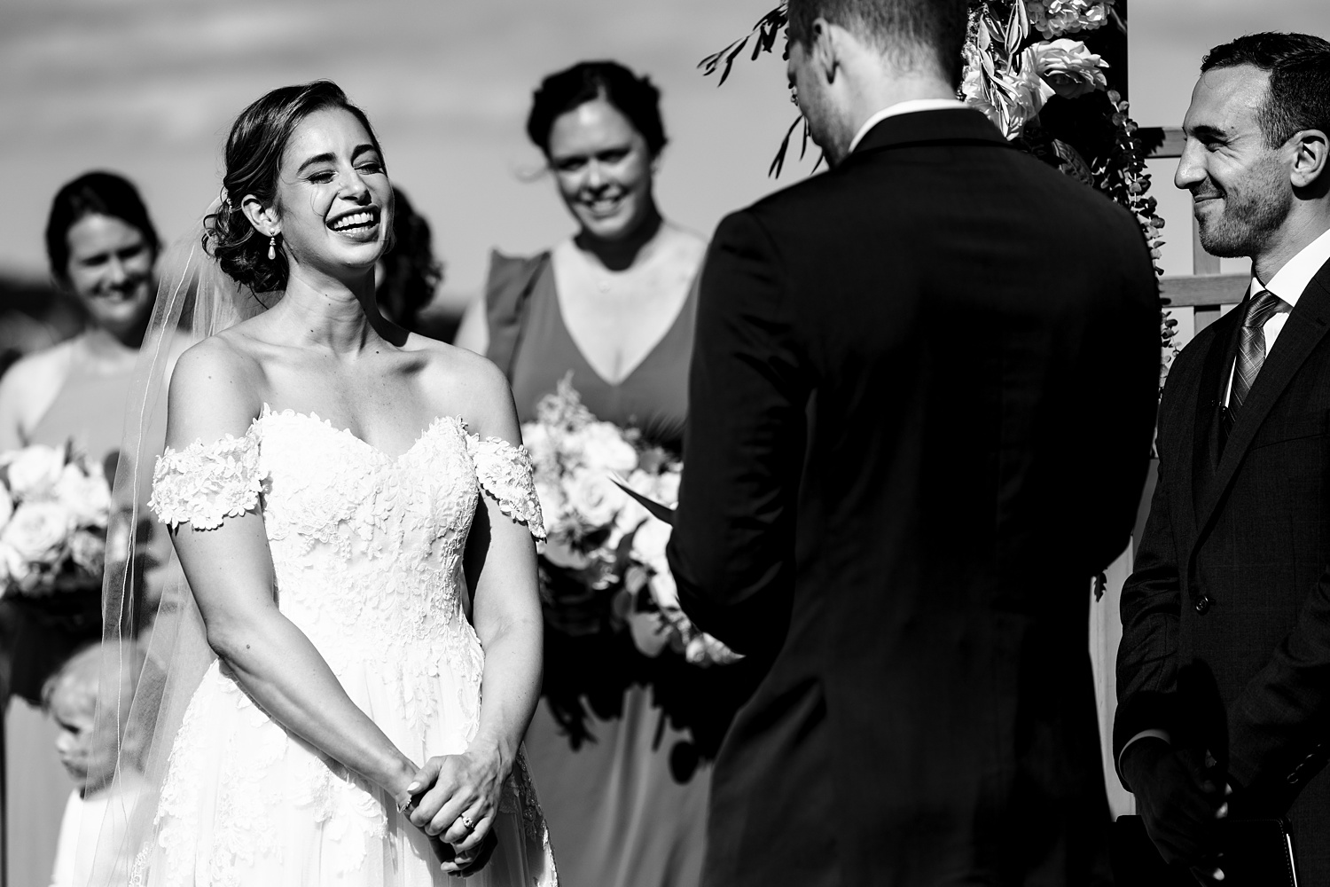 The bride laughs during the vows on her wedding day at Stageneck Inn in York Maine