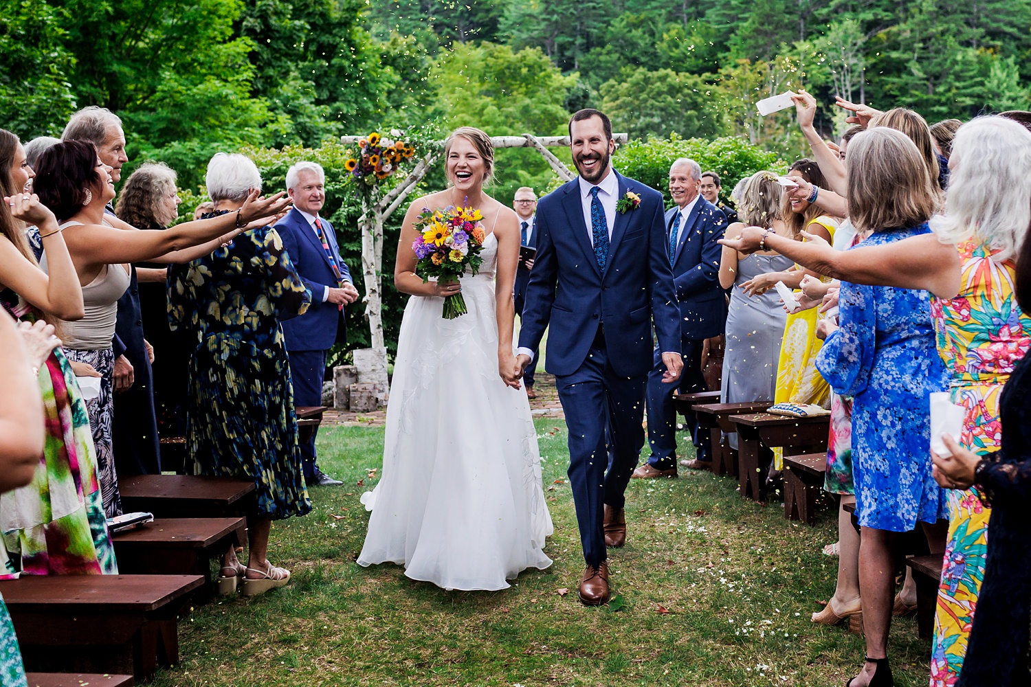 Walking back up the aisle during a petal toss on the wedding day at The Preserve at Chocorua in Tamworth NH