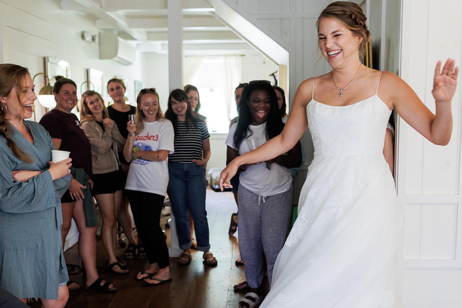 Bride twirls for her friends on her wedding day