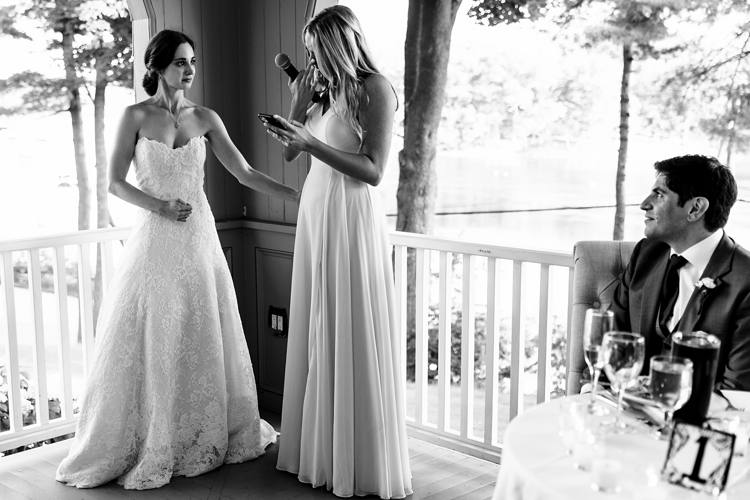 The sister of the bride tears up and the bride comforts her at York Golf and Tennis Club in Maine