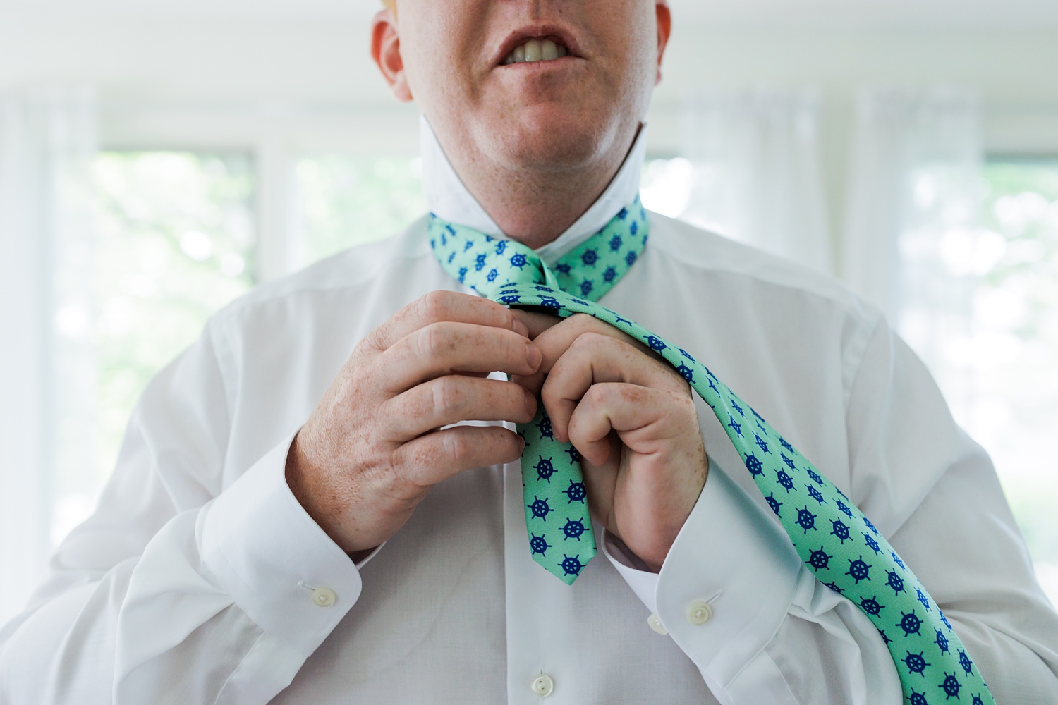 The groom gets his tie all figured out