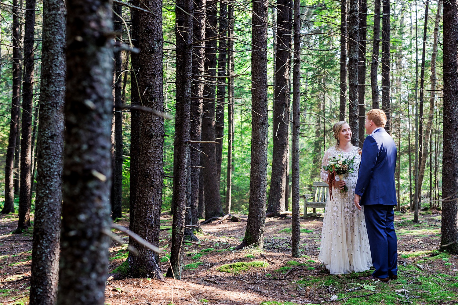Bride smiles at the groom in the woods of Scarborough Maine