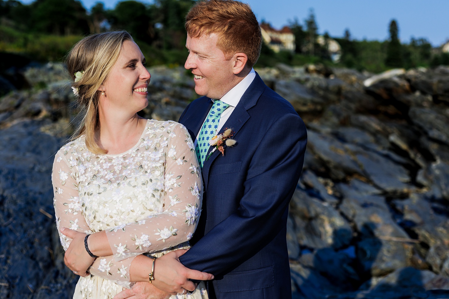 Bride and groom laugh as they spend time out on the rocks in Prout's Neck Maine