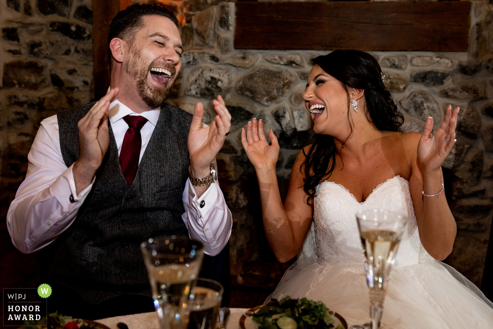 Award Winning Image from a Philadelphia wedding where the couple laugh at a toast