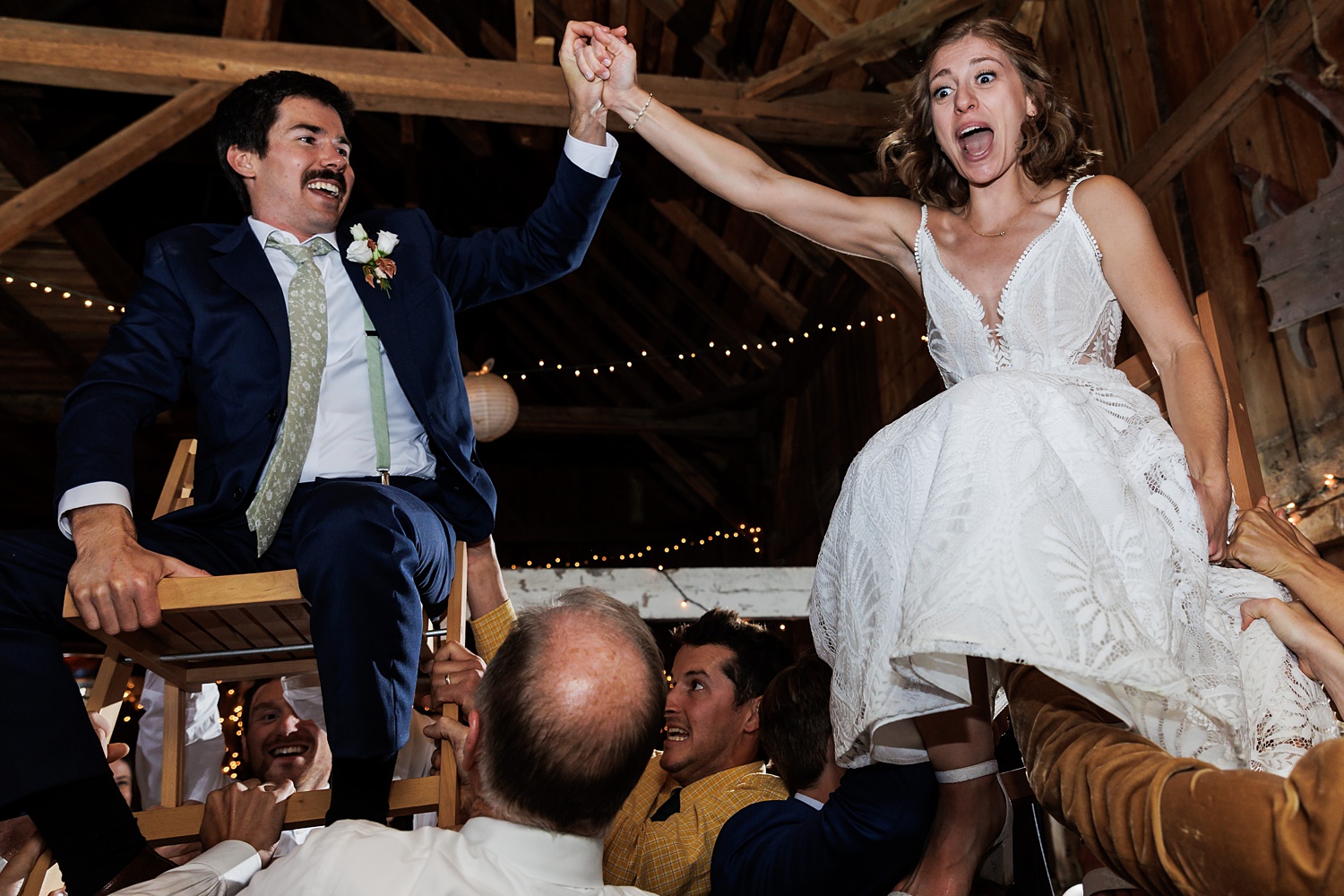 The horah celebration gets wild in the barn at the wedding reception