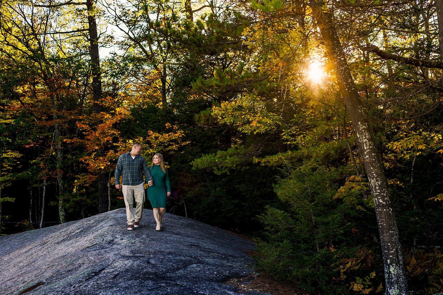 Walking in the woods of the White Mountains New Hampshire for their engagement session in fall