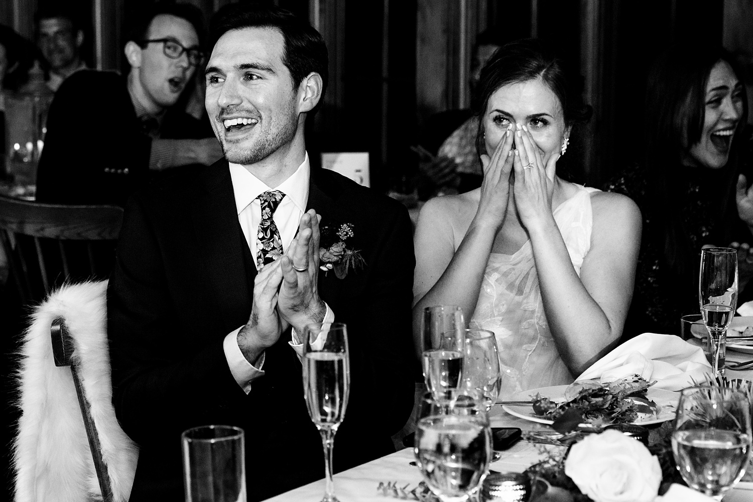 The bride and groom tear up at the toasts during the wedding reception in Maine