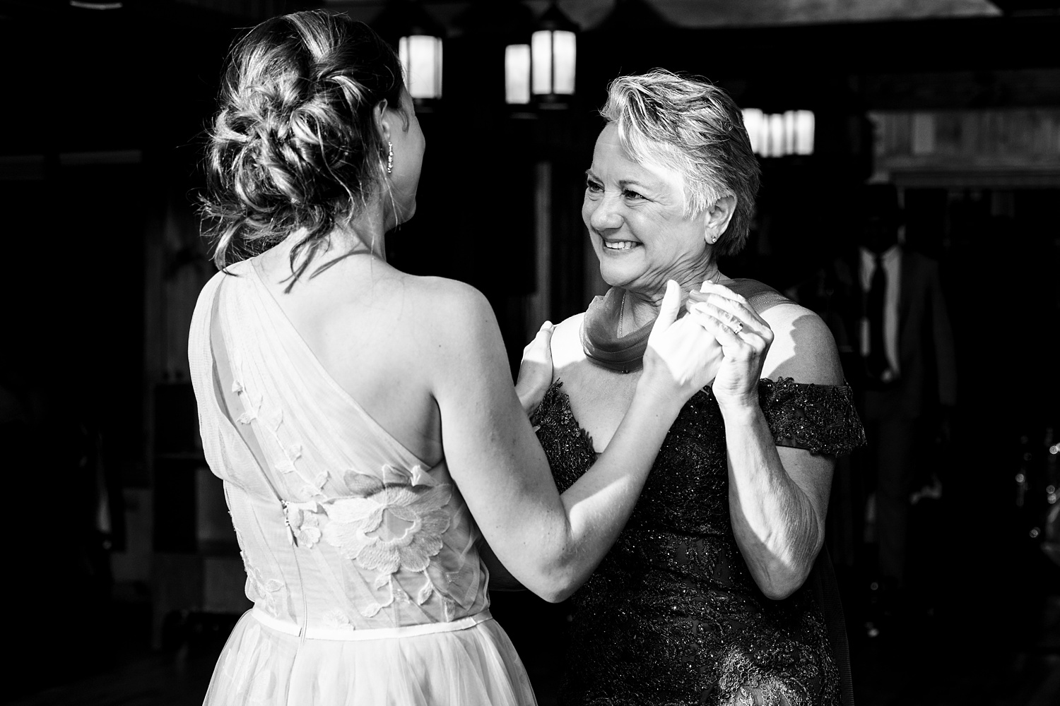 The bride dances with her mom at the wedding day