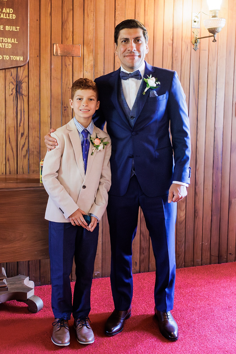 The groom and the ring bearer wait for the ceremony to start at Spurwink Church Maine