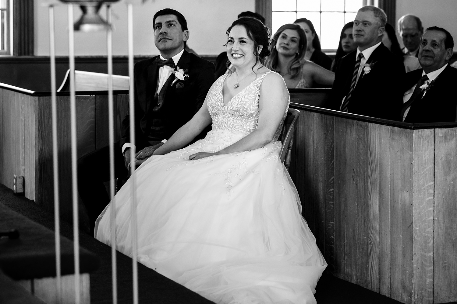 The bride and groom listen to readings on the wedding day
