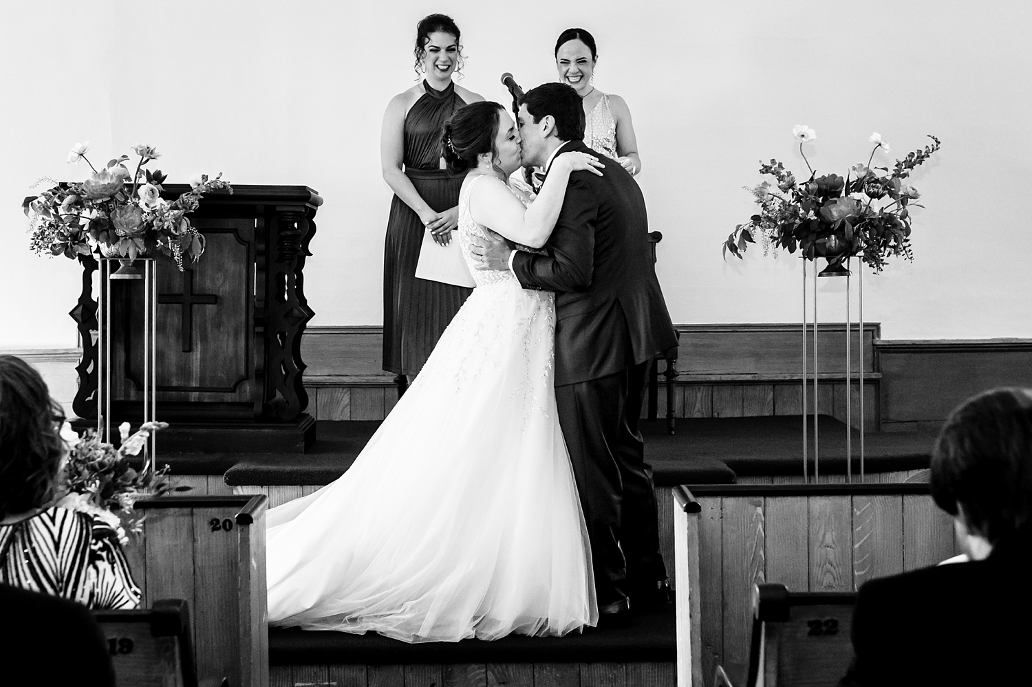 The first kiss of the bride and groom on their wedding day