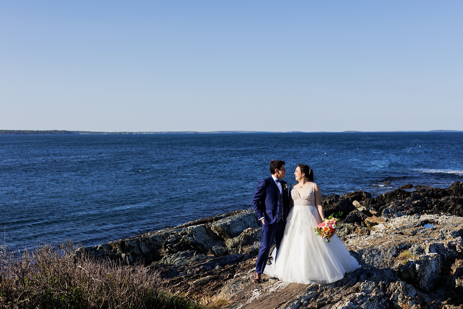 Bride and groom smiling at one another at Trundy Point in Cape Elizabeth Maine