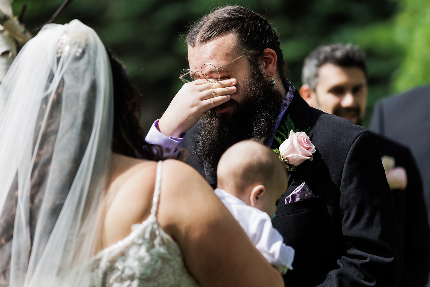 The groom tears up reading his vows during the ceremony