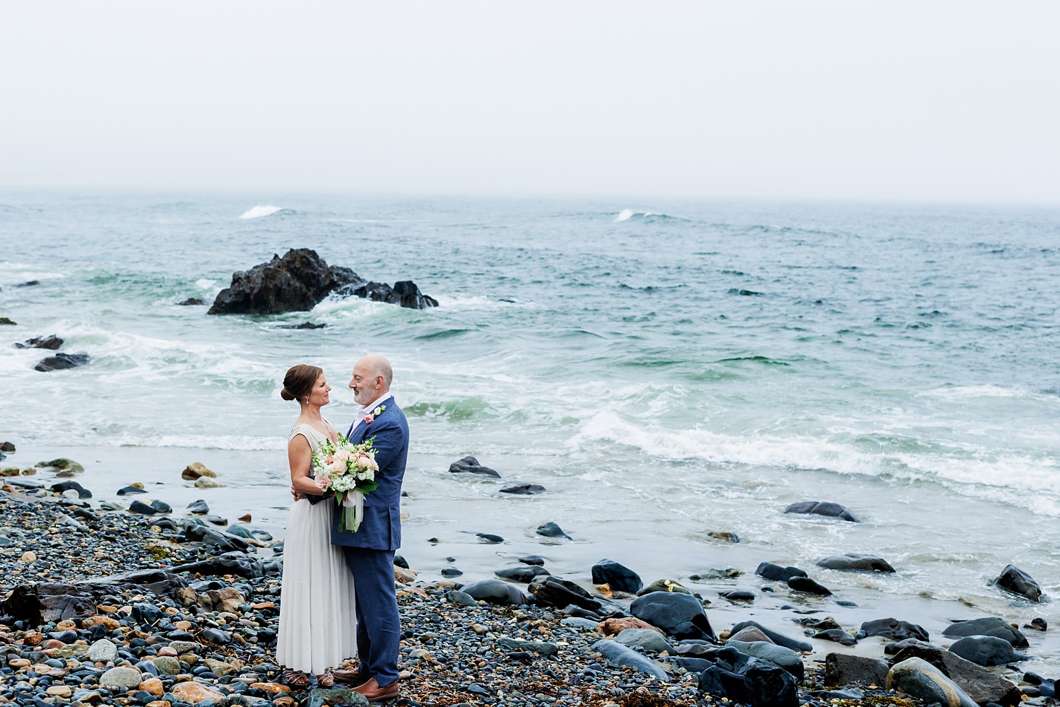 The newlyweds after their sunrise elopement on one of the beaches of Marginal Way Maine