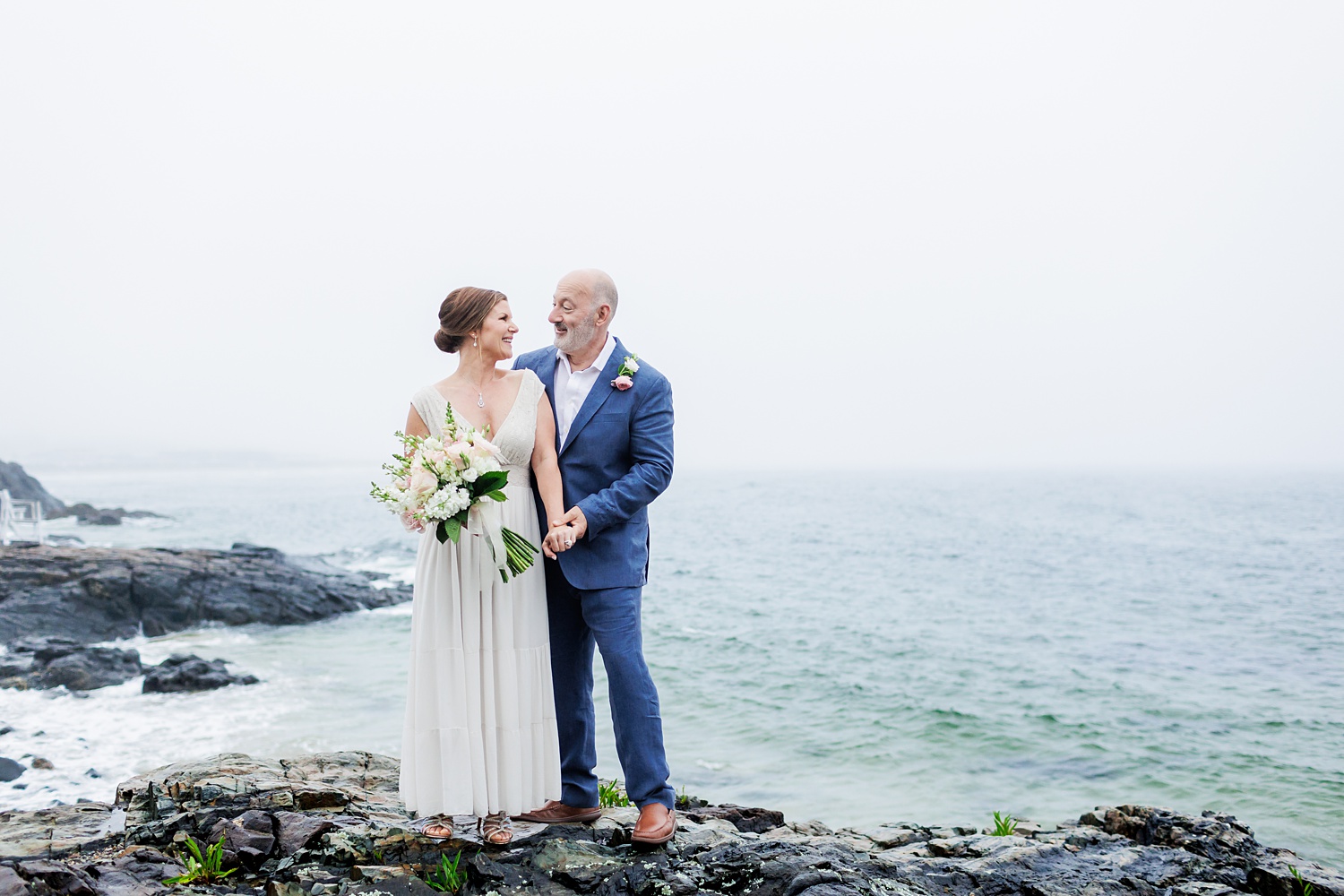 A laugh on the cliffs overlooking the views on Marginal Way Maine for the couple who eloped