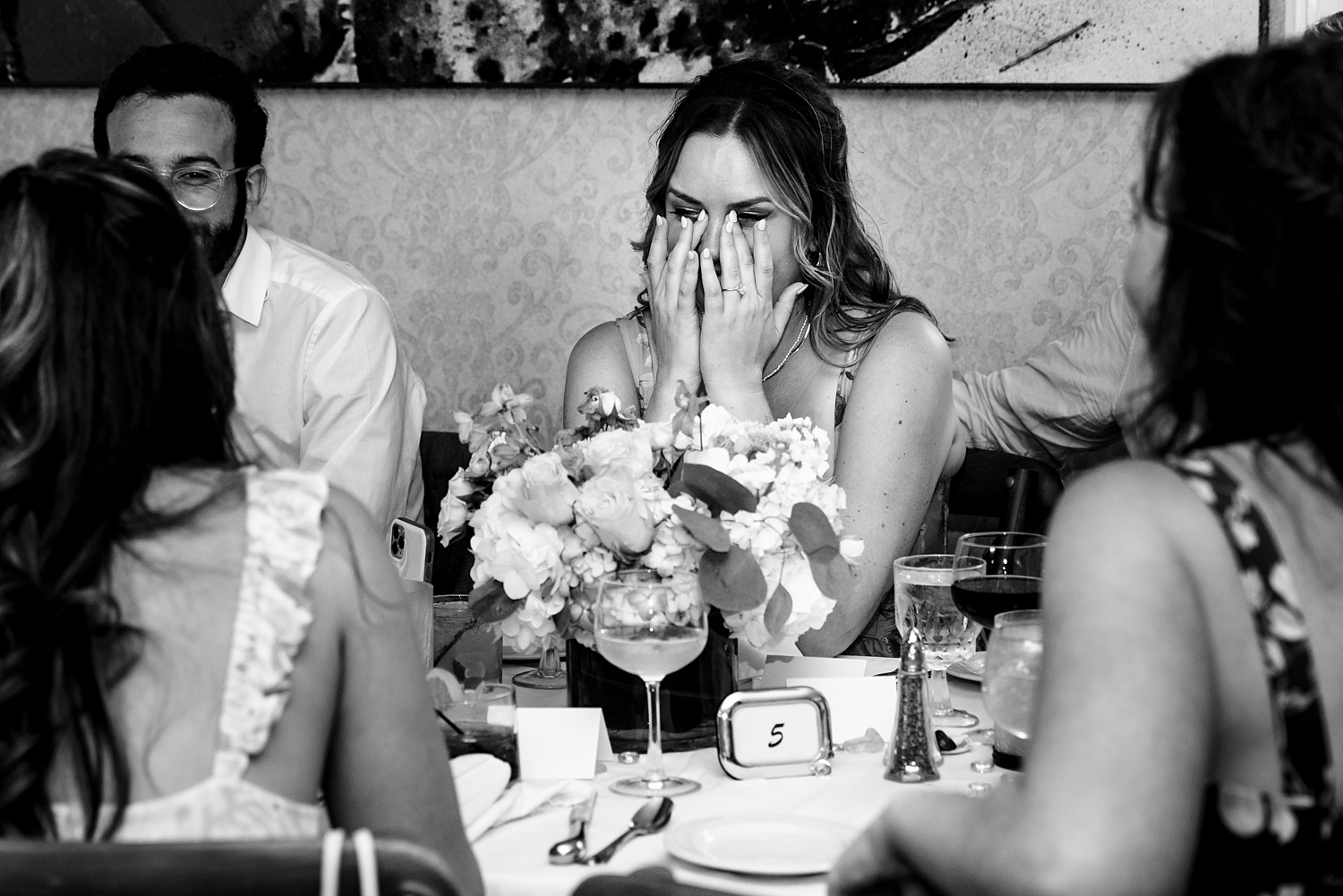 Friends laugh and tear up at the wedding day toasts