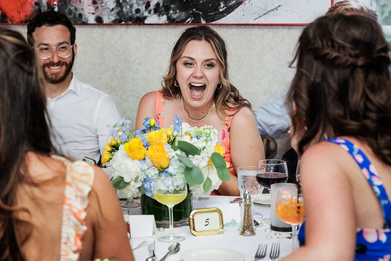 Friends laugh and tear up at the wedding day toasts