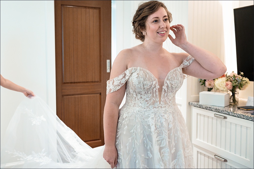 The bride admires her wedding day attire